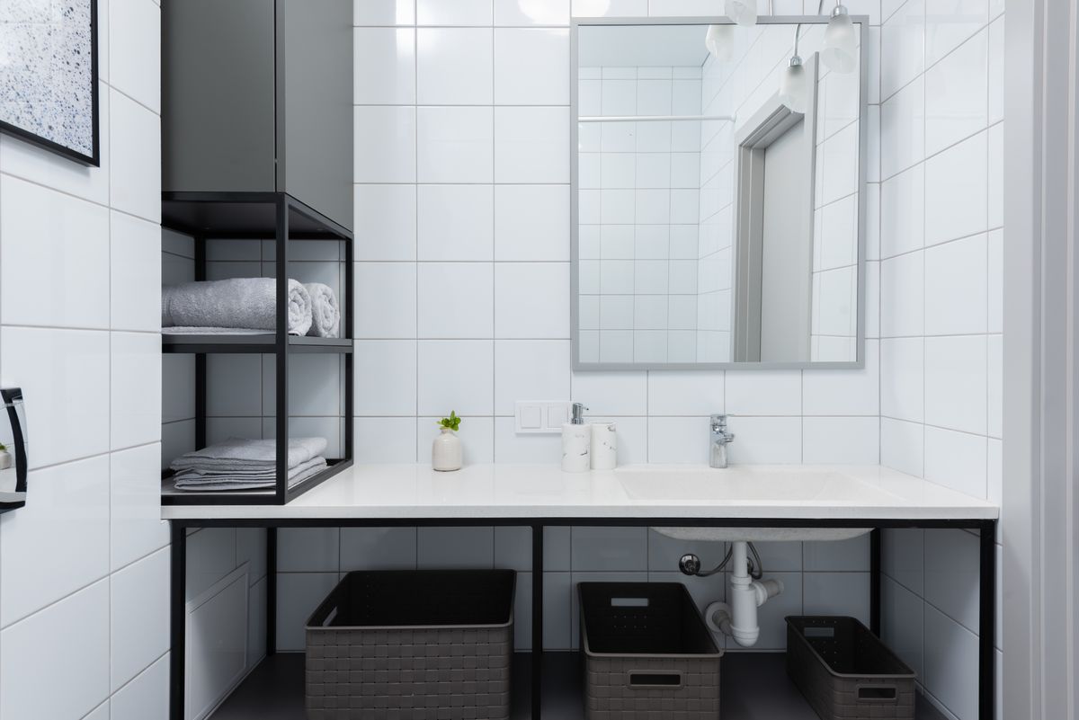 Clean, organized bathroom with polished fixtures and folded towels